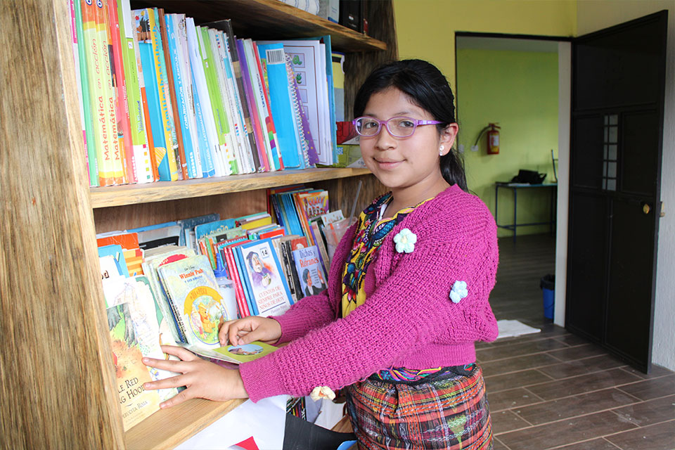 Niña guatemalteca sonriendo en un entorno educativo del Centro Familiar de NPH.